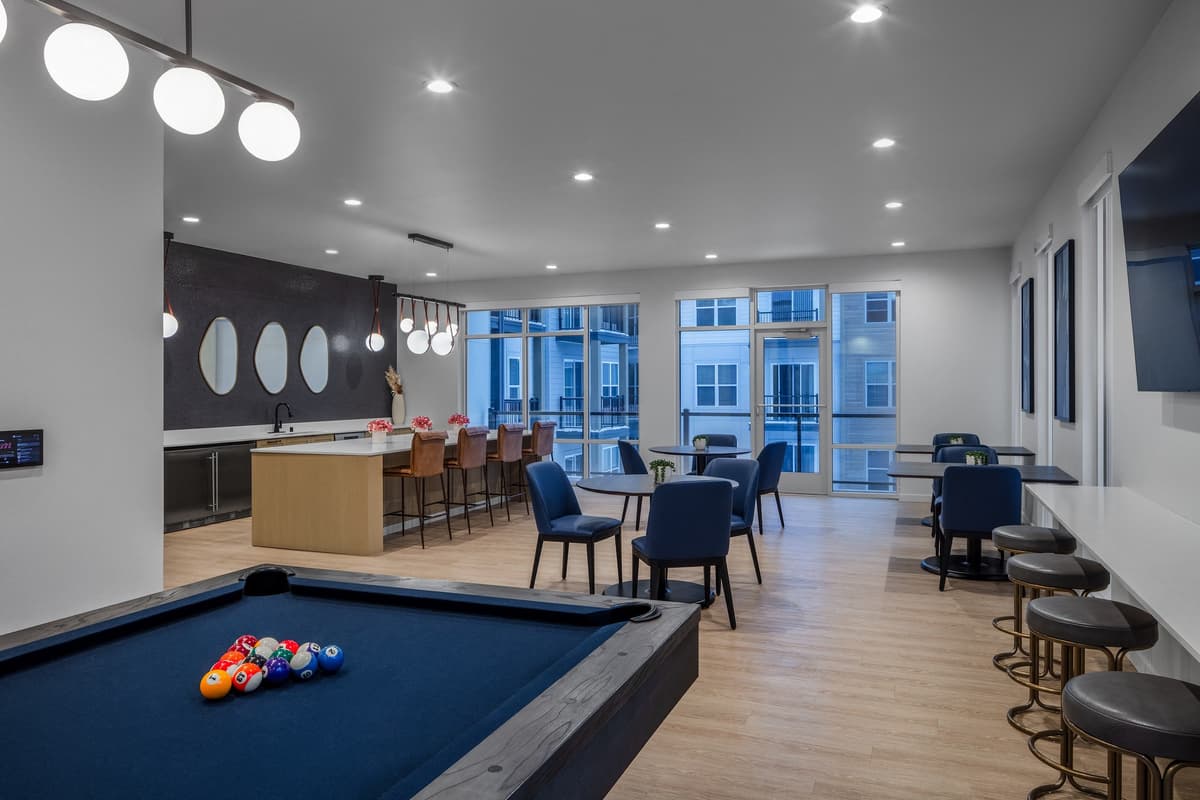 Milwaukee County apartments for rent - image - a communal area with a pool table and tables and chairs and a bar