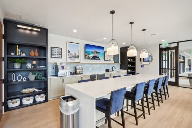 Milwaukee County apartments for rent - image - A modern kitchen with a long white island and blue chairs