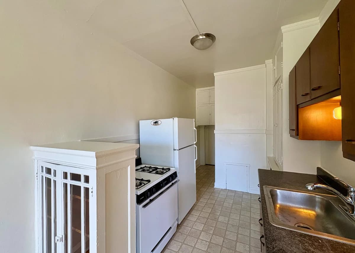 Milwaukee County apartments for rent - image - Charming kitchen with classic appliances, a cozy layout, and warm wooden cabinetry.