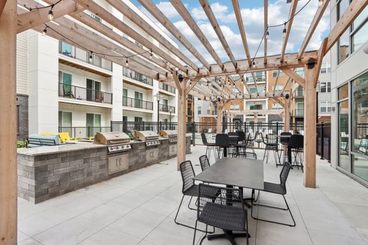 Milwaukee County apartments for rent - image - A patio with tables and chairs is covered by a wooden roof