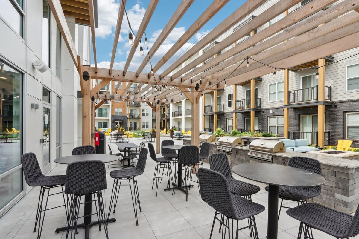 Milwaukee County apartments for rent - image - A patio with tables and chairs is covered by a wooden roof